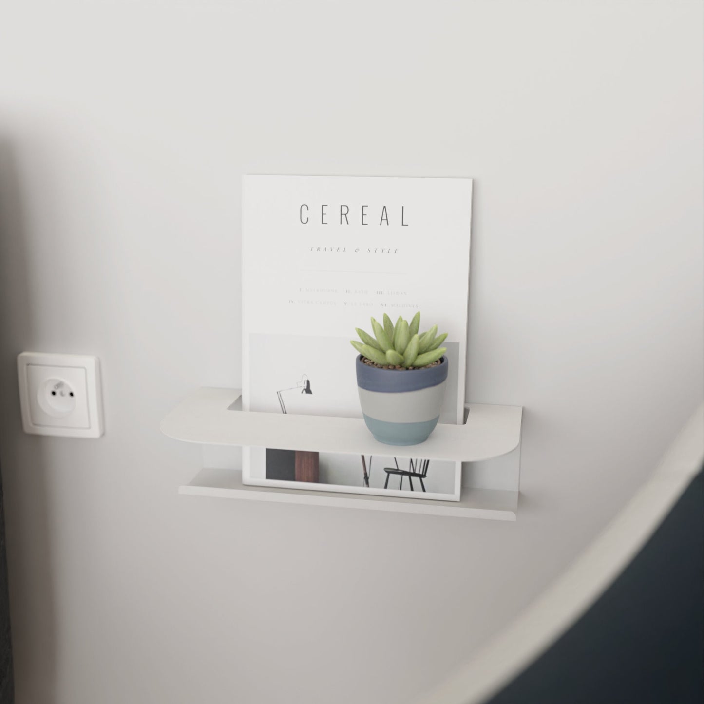 Modern white metal wall shelf holding a glass of water and a book, perfect for minimalist home decor by DnzHomeDesign.