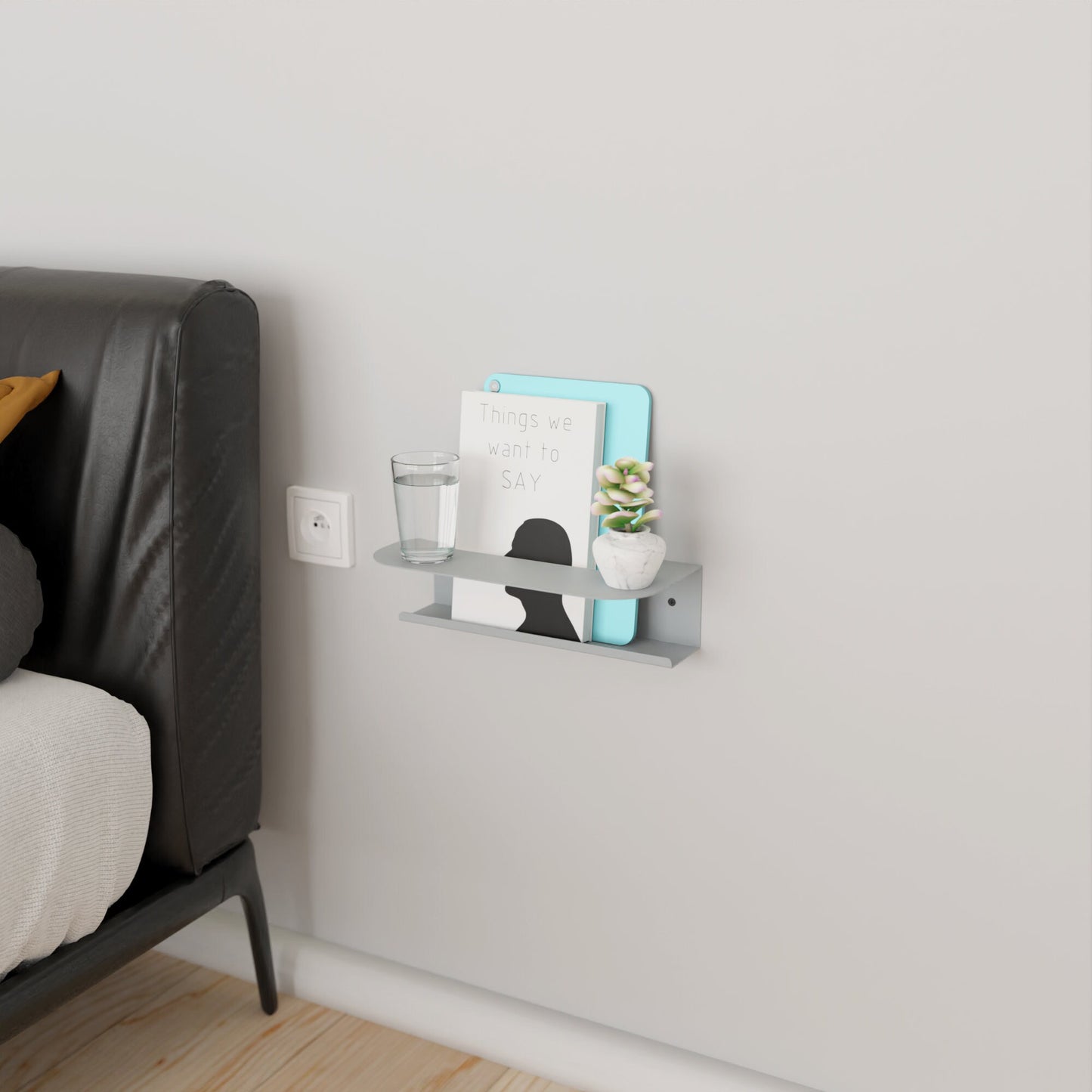 Modern gray metal wall shelf holding a glass of water and a book, perfect for minimalist home decor by DnzHomeDesign.