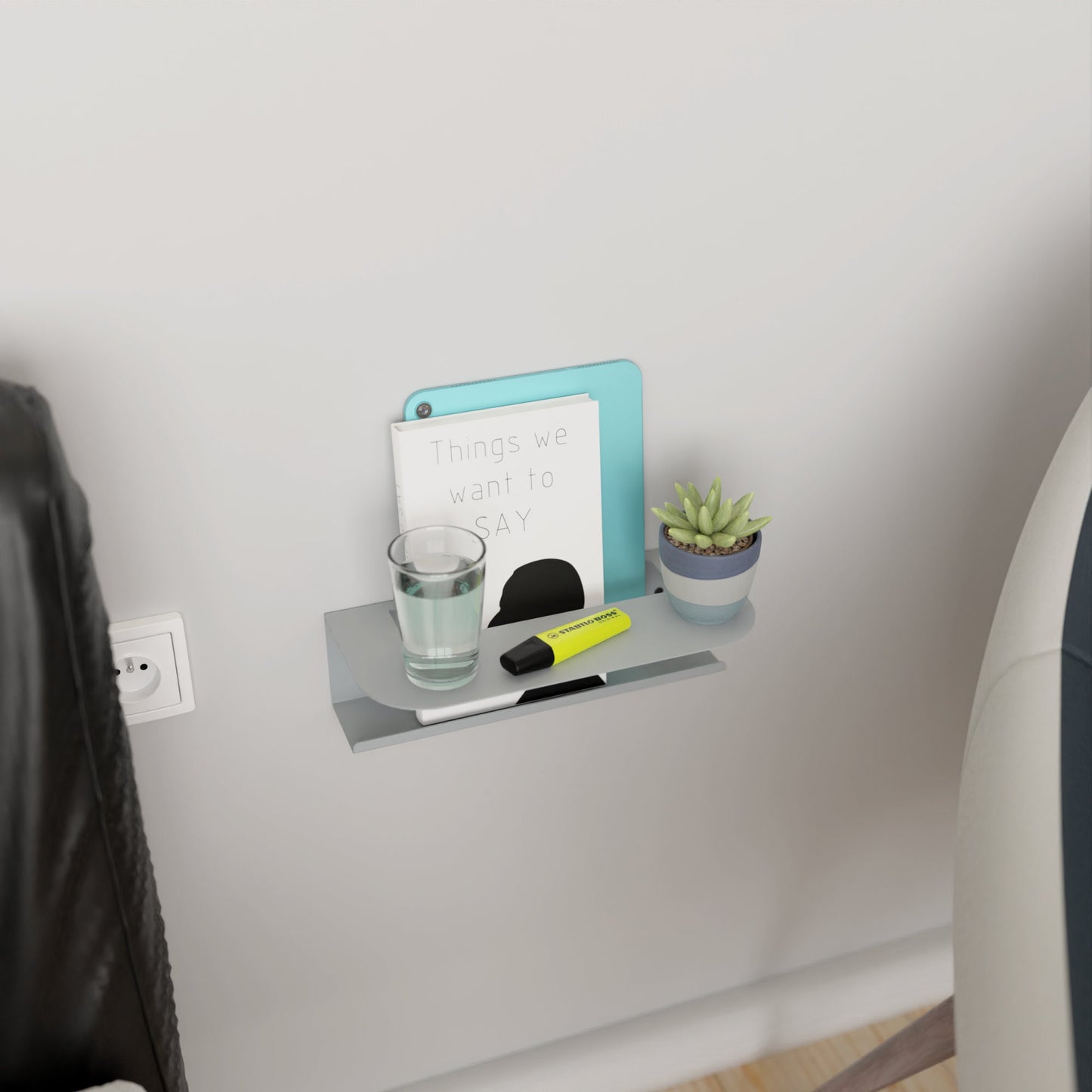 Modern gray metal wall shelf holding a glass of water and a book, perfect for minimalist home decor by DnzHomeDesign.