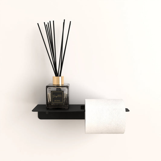 Black metal toilet paper holder, golden-capped fragrance diffuser, bathroom shelf, minimalist design.